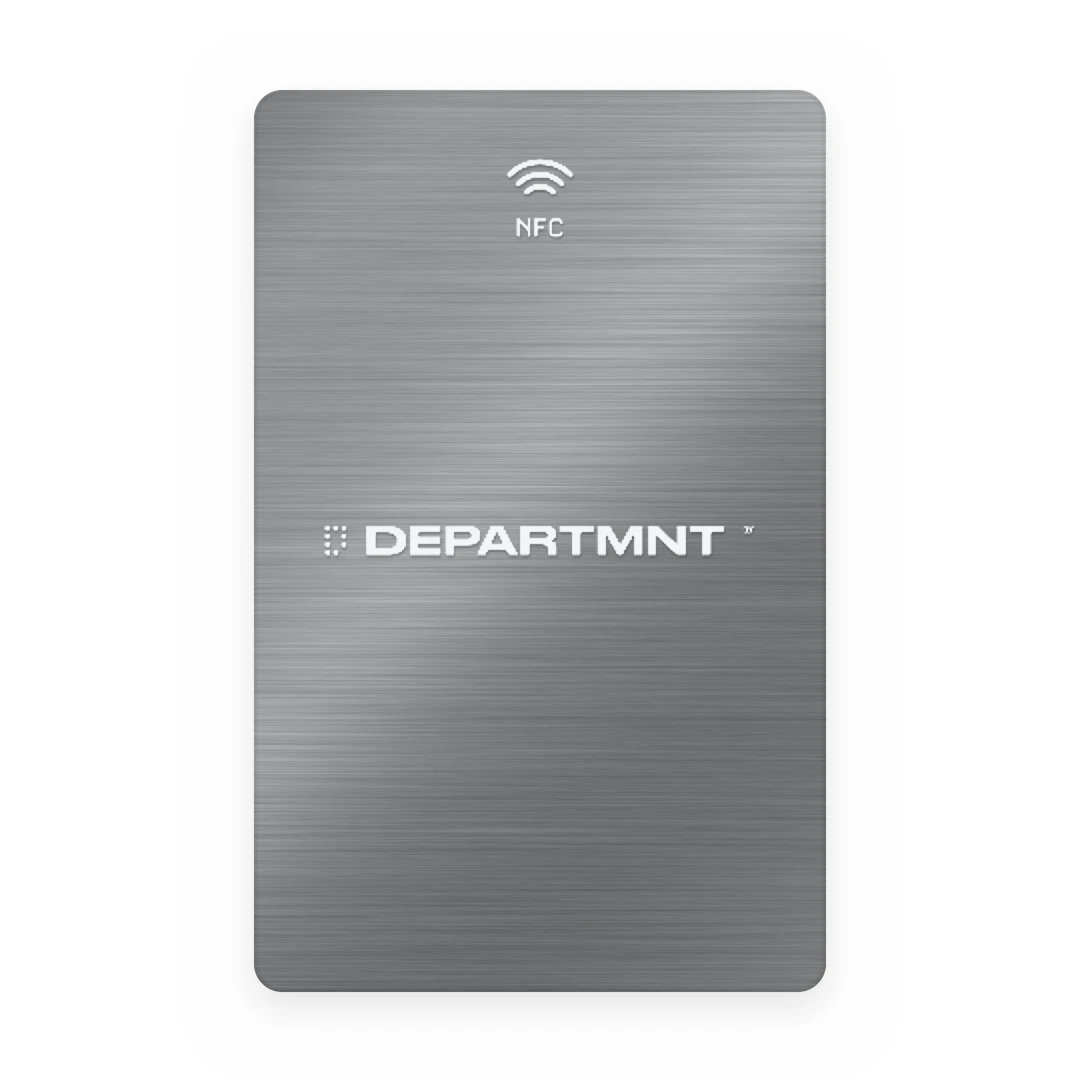 Metal card render: a brushed silver portrait card with the NFC mark and the DEPARTMNT wordmark