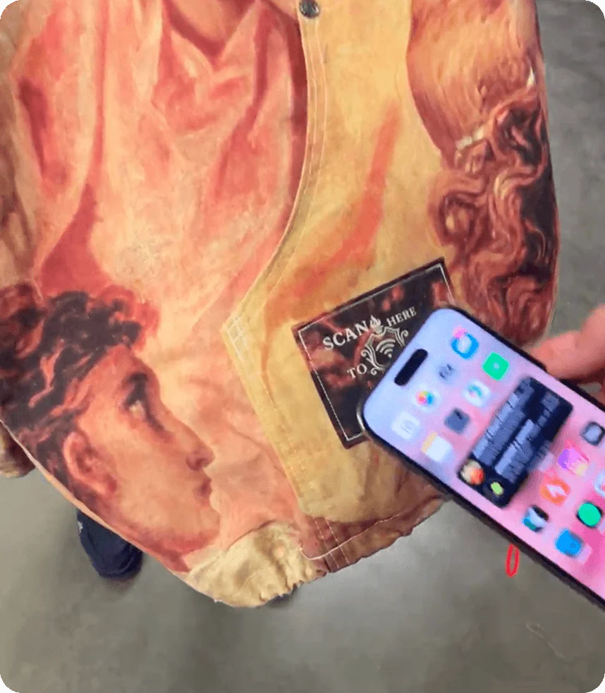 The Rough Cut Renaissance bomber, its tagged patch tapped with a phone